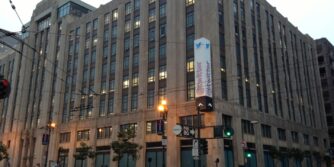 Picture of Twitter headquarters, a large, tall building, in San Francisco